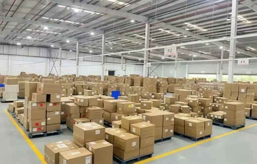 Cartons of packed steering racks stacked on pallets in the warehouse