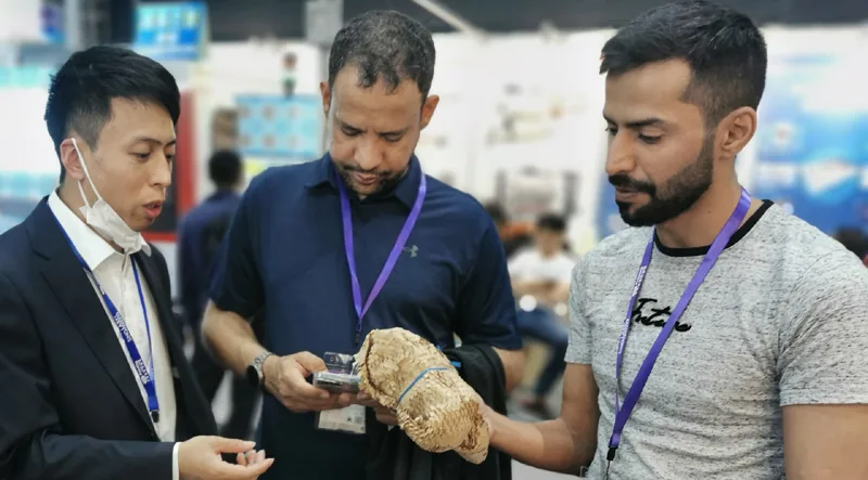 Emerson engineer showing honeycomb paper to overseas buyers at a packaging exhibition