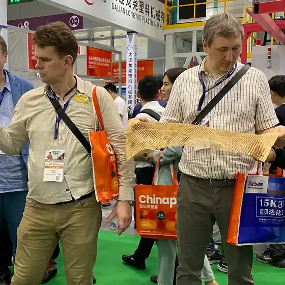 Customers reviewing finished paper samples at the Emerson stand