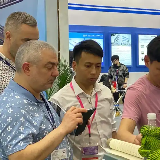 Buyers inspecting honeycomb paper cushioning at the stand