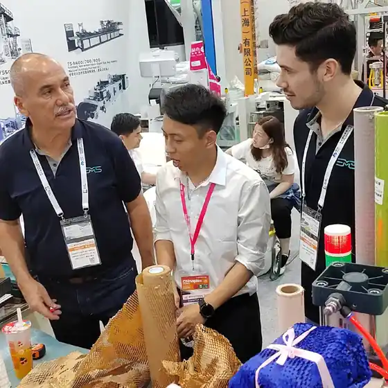 Buyers handling finished honeycomb paper at the Emerson stand