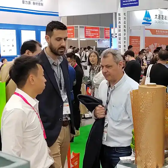 Visitors examining honeycomb wrap at a packaging exhibition