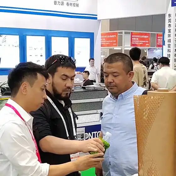 Overseas visitors with fanfold kraft paper at the Emerson stand