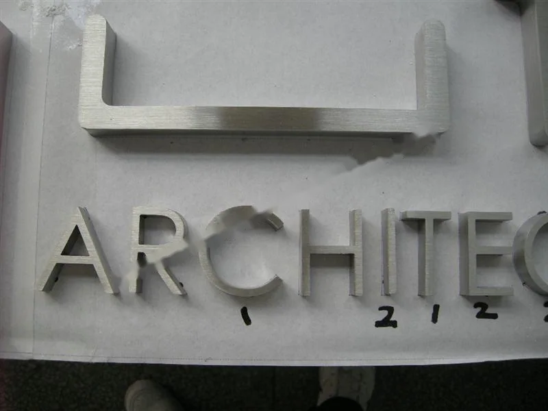 Brushed Stainless Steel relief letter sign, reference 101, photographed in the Super Enseigne workshop