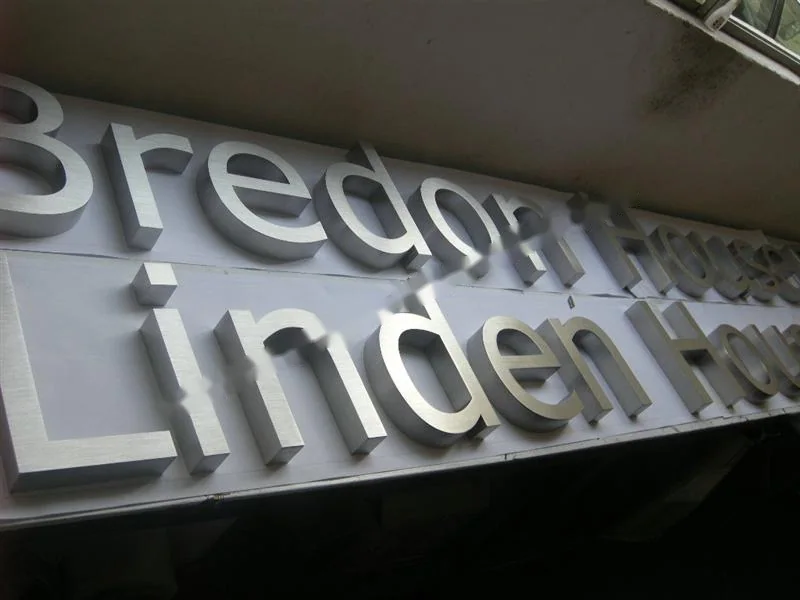 Brushed Stainless Steel relief lettering sign, reference 103, photographed in the Super Enseigne workshop