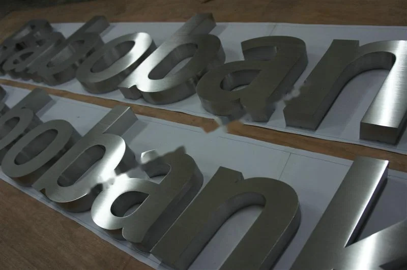 Brushed Stainless Steel relief lettering sign, reference 109, photographed in the Super Enseigne workshop
