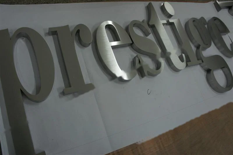 Brushed Stainless Steel relief letter sign, reference 111, photographed in the Super Enseigne workshop