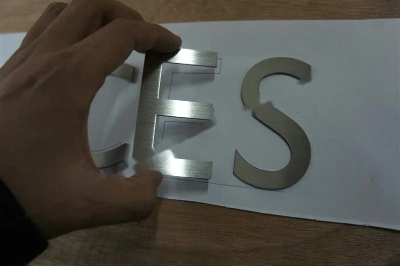 Brushed Stainless Steel relief letter sign, reference 112, photographed in the Super Enseigne workshop