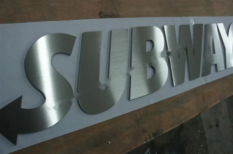 Brushed Stainless Steel relief letter sign, reference 116, photographed in the Super Enseigne workshop