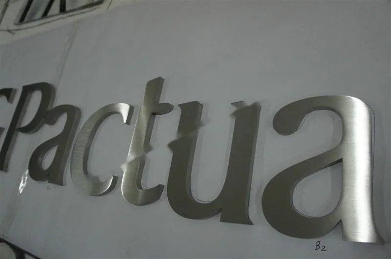 Brushed Stainless Steel relief lettering sign, reference 118, photographed in the Super Enseigne workshop