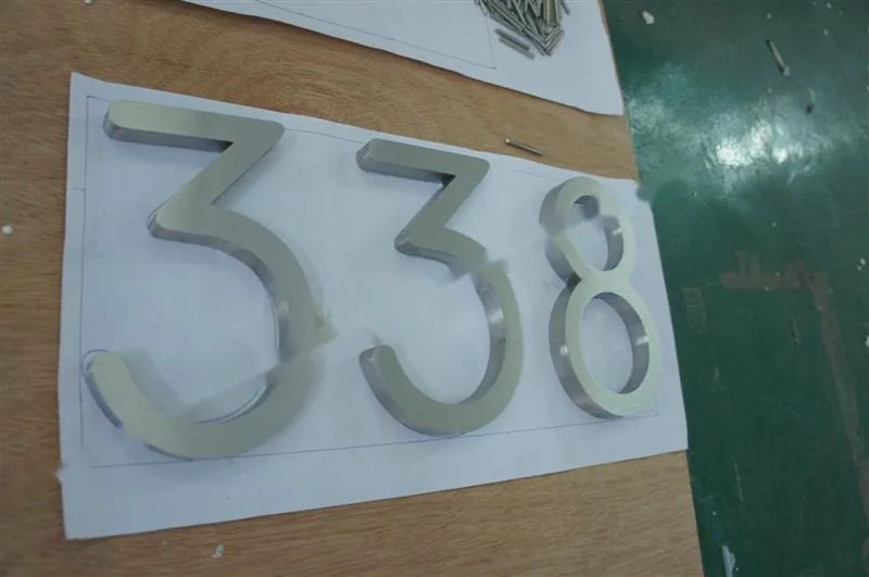 Brushed Stainless Steel relief lettering sign, reference 120, photographed in the Super Enseigne workshop