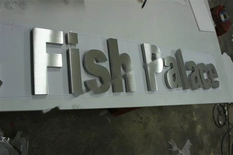 Brushed Stainless Steel relief letter sign, reference 121, photographed in the Super Enseigne workshop