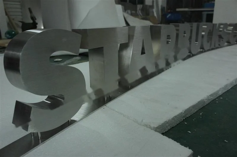 Brushed Stainless Steel relief lettering sign, reference 124, photographed in the Super Enseigne workshop