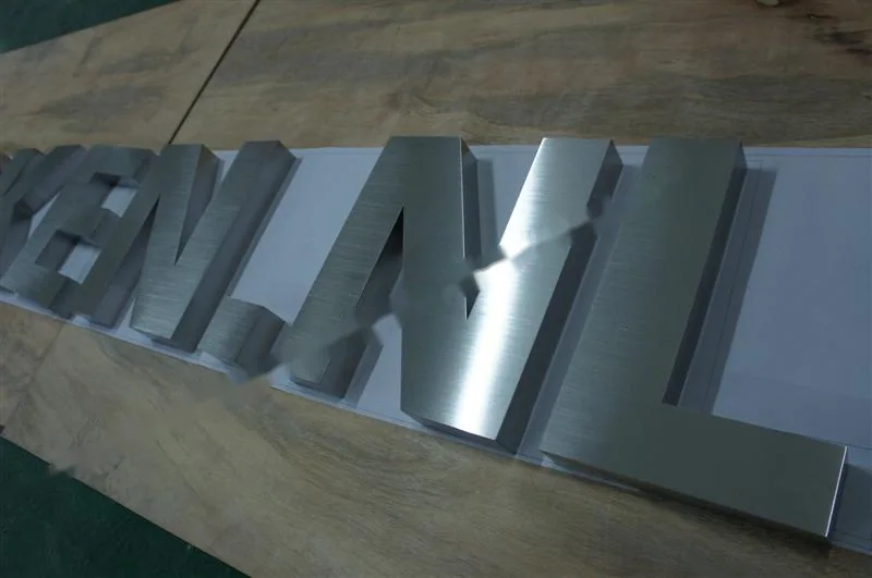 Brushed Stainless Steel relief lettering sign, reference 128, photographed in the Super Enseigne workshop