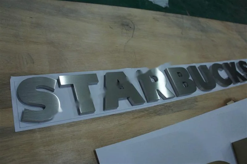 Brushed Stainless Steel relief letter sign, reference 129, photographed in the Super Enseigne workshop
