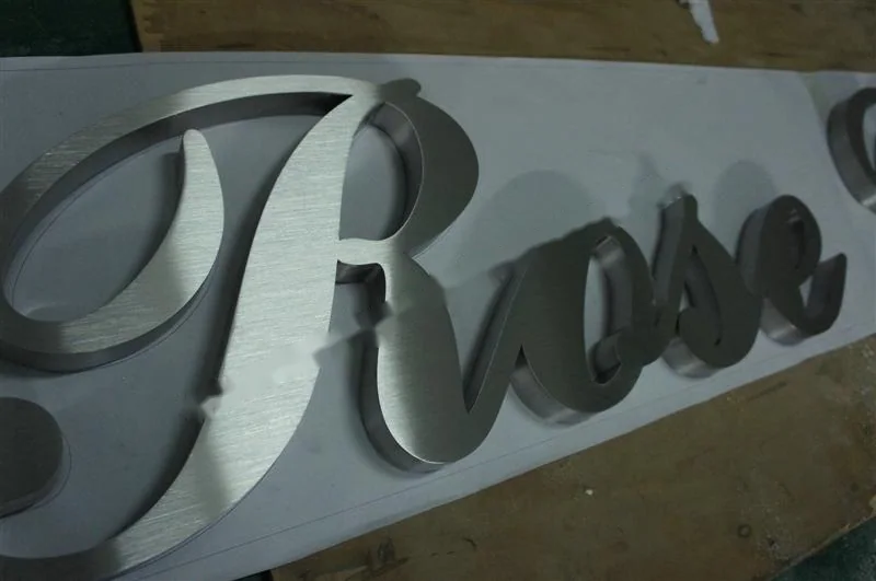 Brushed Stainless Steel relief lettering sign, reference 134, photographed in the Super Enseigne workshop