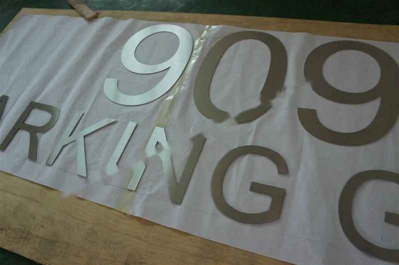 Brushed Stainless Steel relief lettering sign, reference 140, photographed in the Super Enseigne workshop