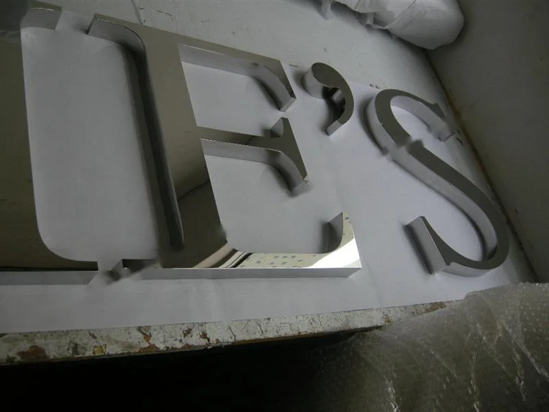 Mirror Polished Stainless Steel relief lettering sign, reference 203, photographed in the Super Enseigne workshop