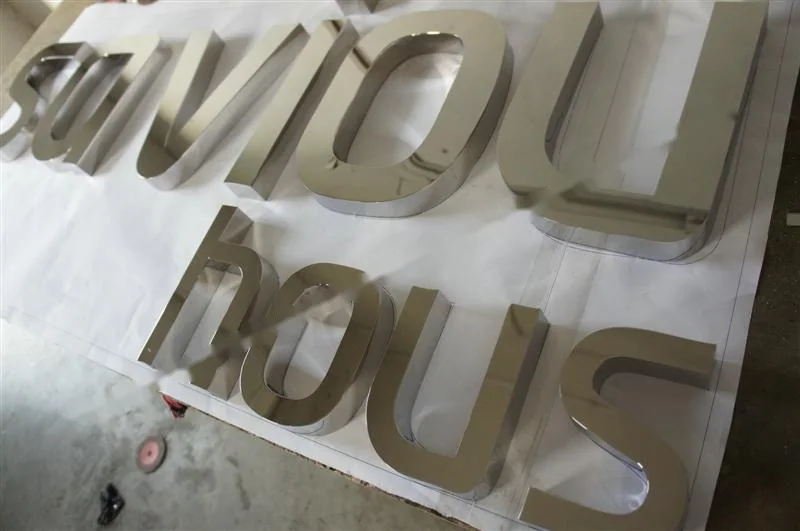 Mirror Polished Stainless Steel relief lettering sign, reference 211, photographed in the Super Enseigne workshop