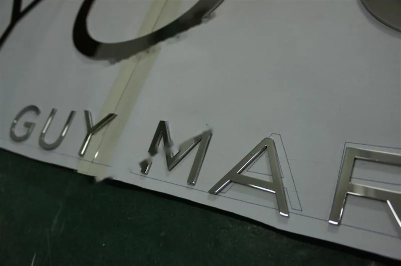 Mirror Polished Stainless Steel relief lettering sign, reference 222, photographed in the Super Enseigne workshop