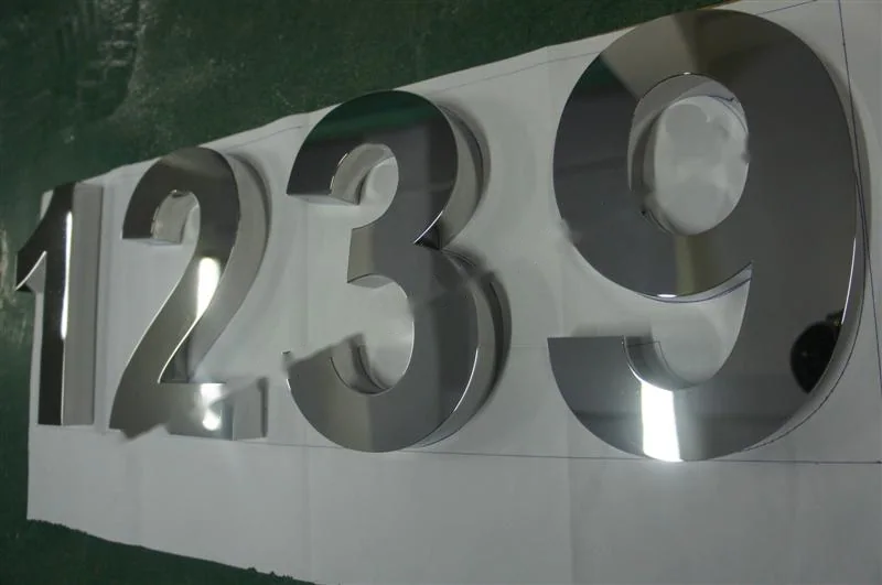 Mirror Polished Stainless Steel flat-cut letter sign, reference 226, photographed in the Super Enseigne workshop