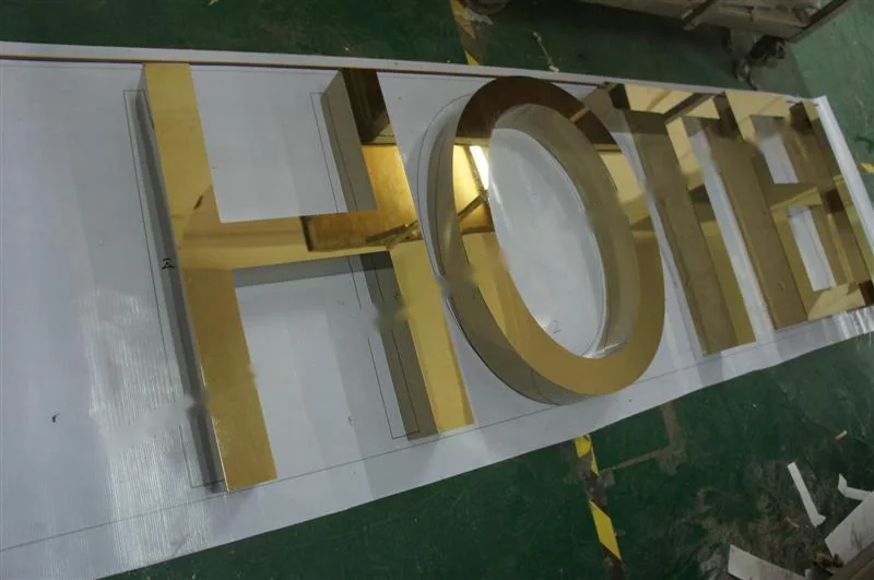 Metal sign letters on the workshop bench before finishing