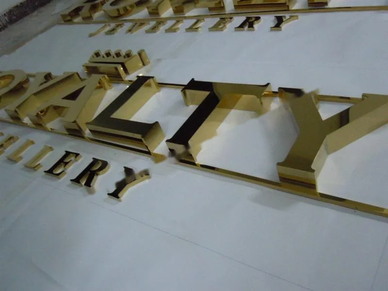 Metal sign letters on the workshop bench before finishing