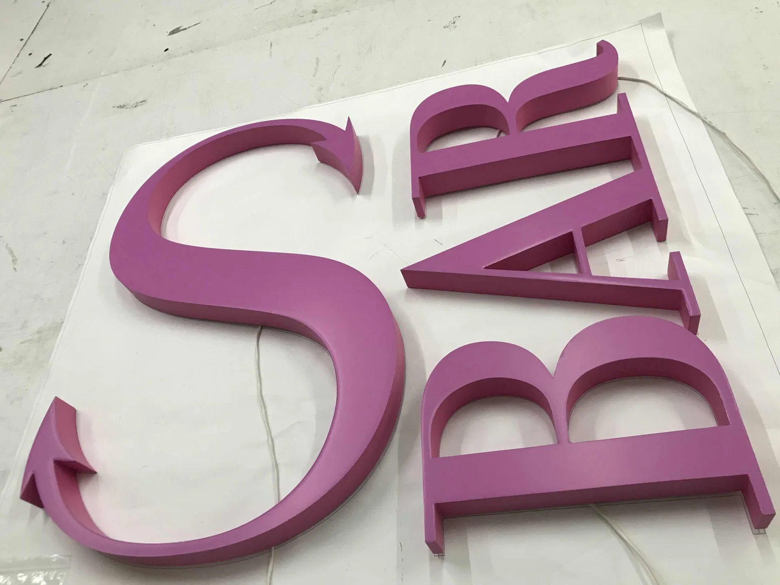Built-up letters lacquered to a single colour reference across the set.