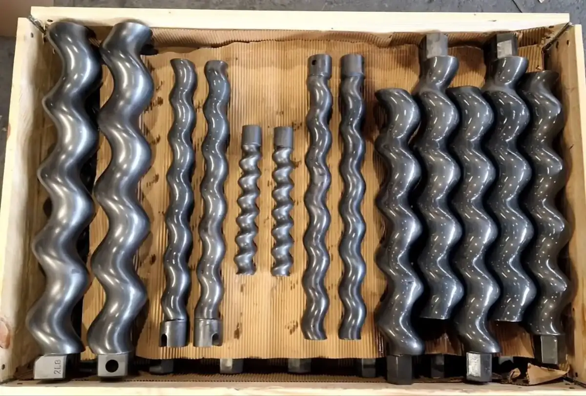 Set of hardened screw pump rotors in a packing crate