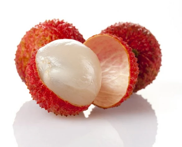 Fresh red lychees on a white background, one peeled to show white flesh and one opened to reveal pink inner skin