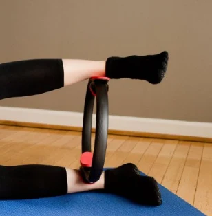 Pilates ring used between the ankles during a floor exercise