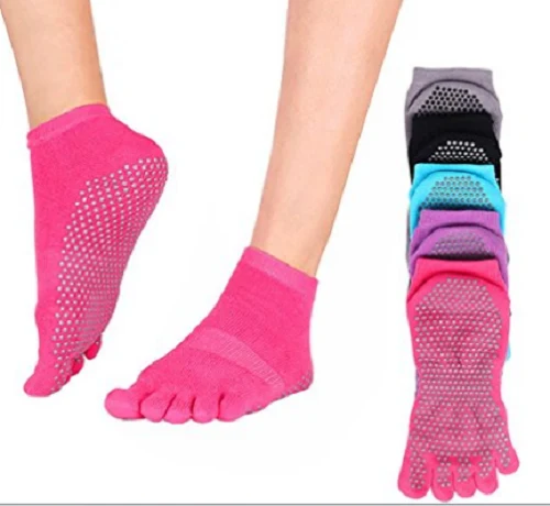 Pink five toe yoga grip socks with silicone sole dots shown with a colour range