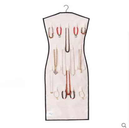Dress shaped jewelry organizer shown hanging against a wall