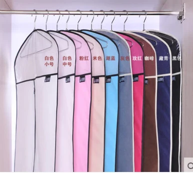 Rail of suit covers in a full colour range hanging in a wardrobe