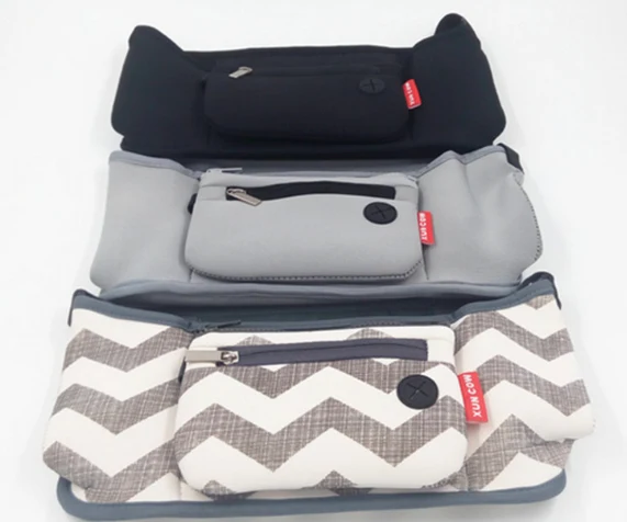 Grab and go stroller organizer loaded with baby bottles and toys