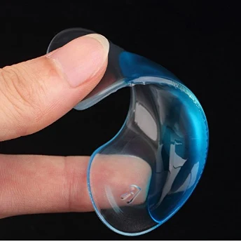 Arch support insole flexed between finger and thumb