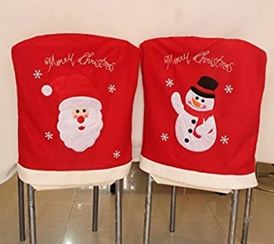 Two Merry Christmas printed chair back covers on dining chairs
