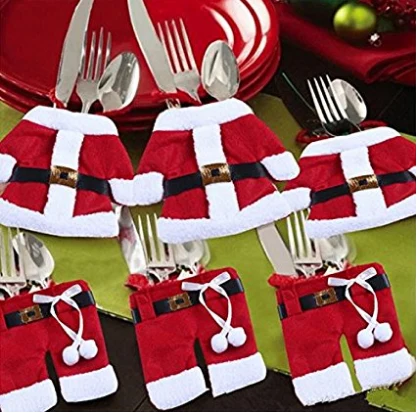 Felt Santa suit cutlery holders arranged on a plate with cutlery