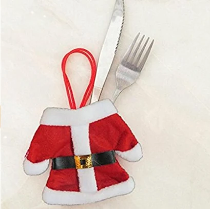 Set of Santa suit cutlery holders on a festive table