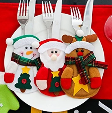 Snowman and Santa felt cutlery holders arranged with cutlery
