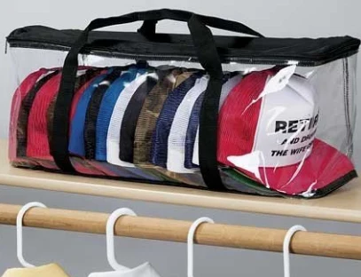 Clear zipped cap and hat storage bag hanging on a rail with caps inside