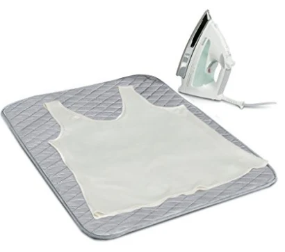 Grey quilted ironing mat shown flat with an iron