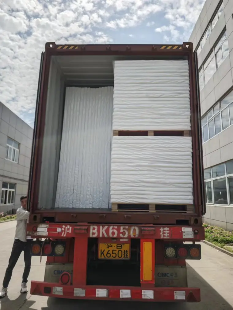Corrugated plastic sheet stacked and strapped in the container