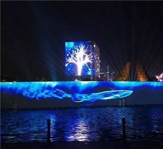 Transparent LED mesh screen over water showing full colour imagery at night