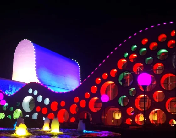 Curved art gallery facade covered in circular full colour LED pixel points