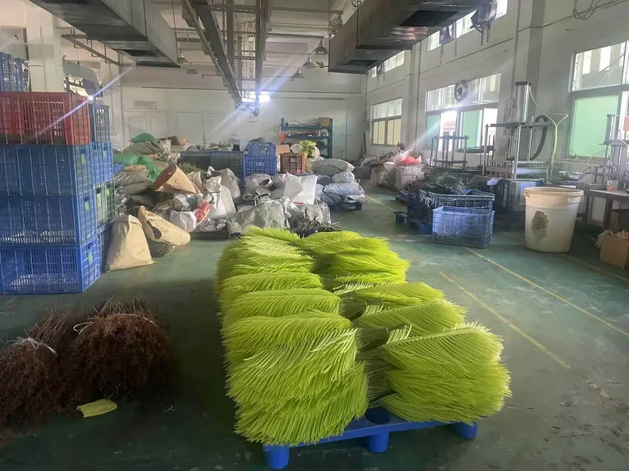 Moulded artificial palm fronds packed flat on a pallet