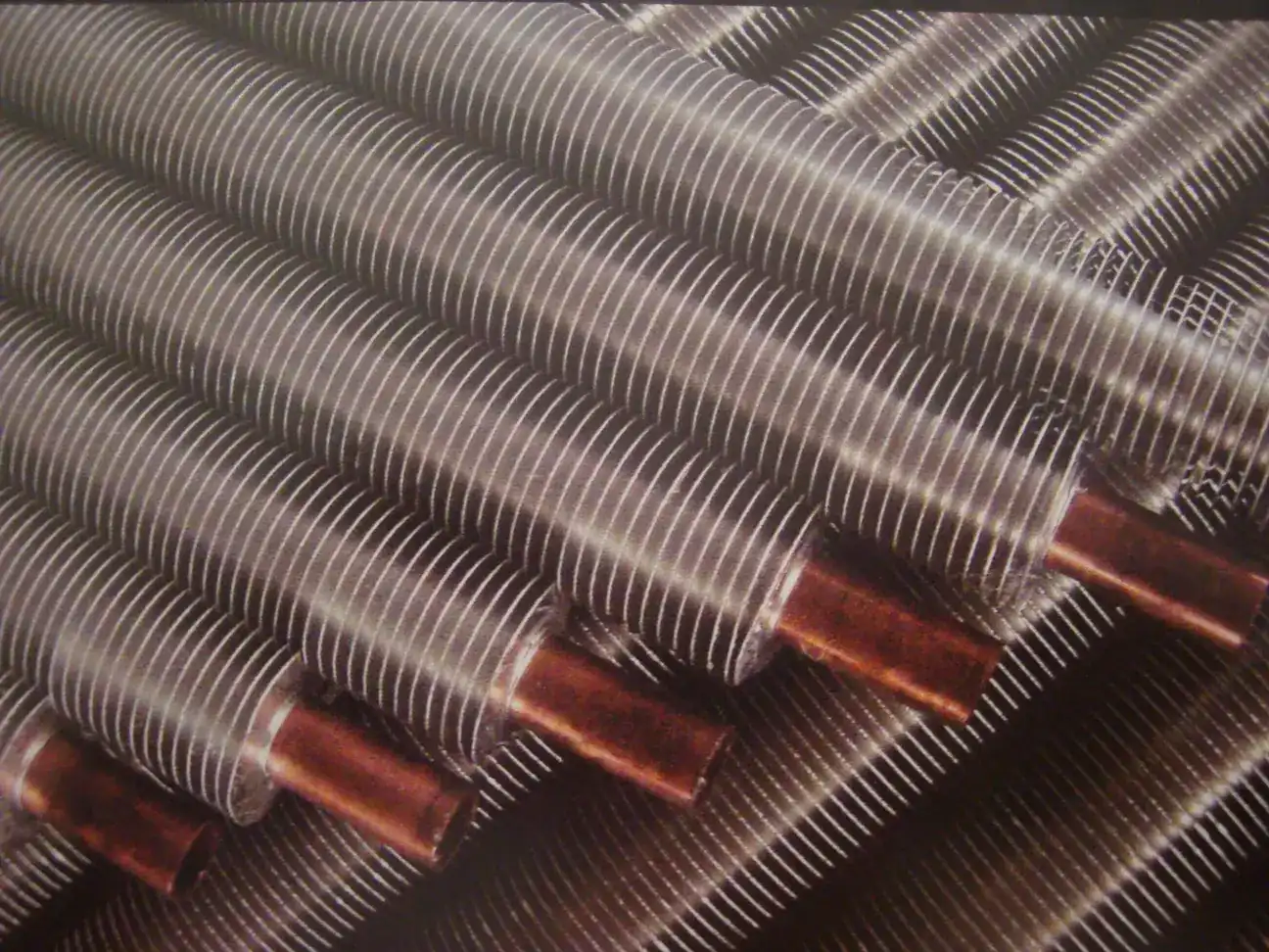 Finned tubes with copper base tube ends stacked in the Fanbang fin tube workshop