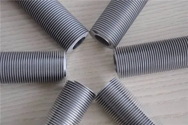 Extruded bimetal fin tube with the fin formed from an aluminium sleeve