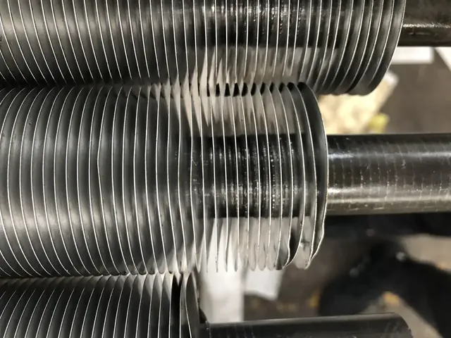 Embedded fin tubes stacked after finning, showing fin pitch along the tube