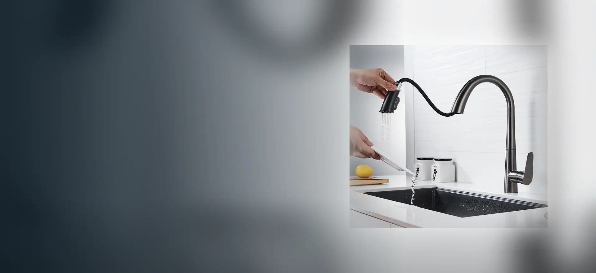 Pull-down kitchen mixer with the spray head drawn out over an undermount sink